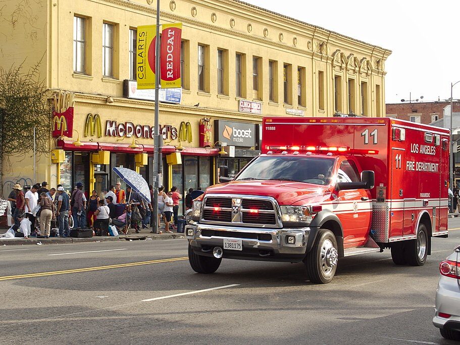 LAFD rescue ambulance 11888 on Alvarado Street near MacArthur Park, with sidewalk peddlers in the background near a McDonald's restaurant.